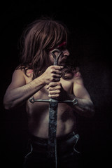 Fototapeta na wymiar Medieval.savage warrior with iron sword