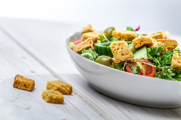 Close-up on a fresh Caesar salad made of vegetables