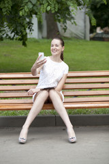 Young woman sits on a bench