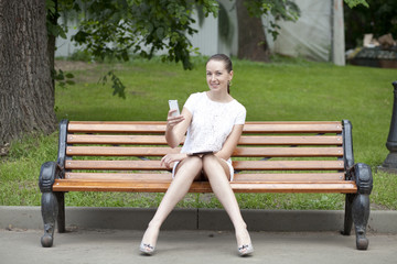 Young woman sits on a bench
