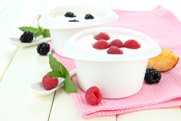 Delicious yogurt with fruit and berries on table close-up