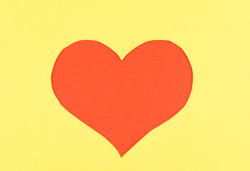 Paper heart on yellow background