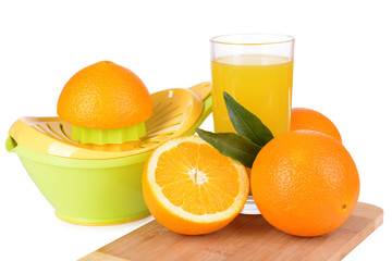 Citrus press and oranges isolated on white
