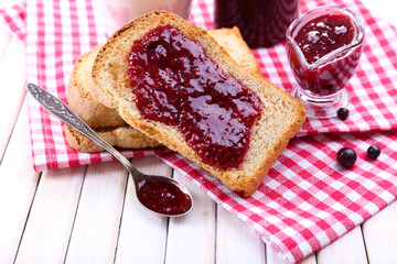 Delicious toast with jam on table close-up
