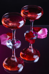 Composition with pink  wine in glasses and  rose petals