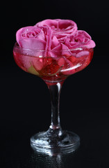 Composition with pink sparkle wine and  roses in glass,