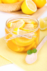 Tasty lemon jam on table close-up