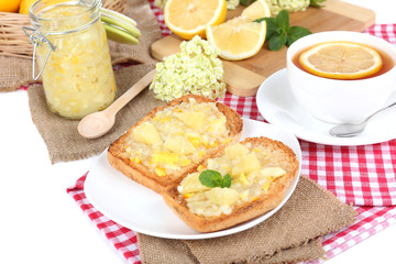 Delicious toasts with lemon jam on plate on table close-up
