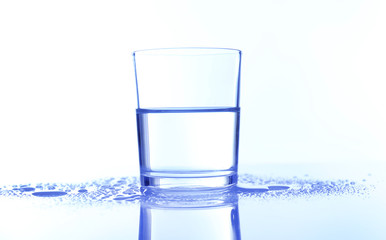 Water in  glass, on blue background