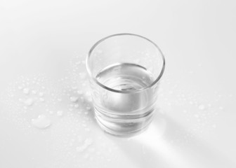 Water in  glass, on  gray background