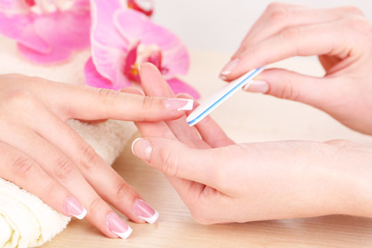 Fototapeta Manicure process in beauty salon close up