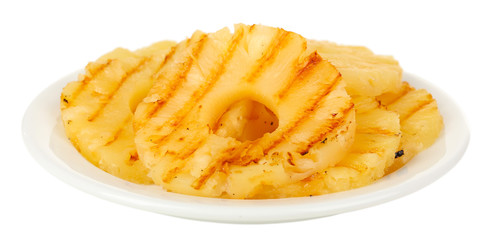 Juicy grilled pineapple on plate isolated on white