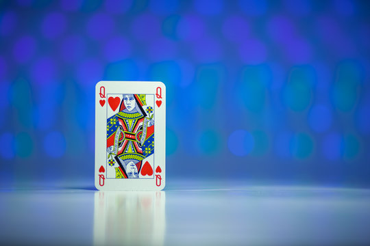 Red heart queen playing card with blue background