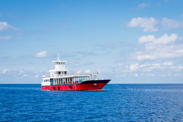 Passenger ferry boat in open waters over against blue sky