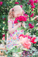 Obraz na płótnie Canvas happy girl with roses in garden