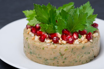white bean pate with nuts and pomegranate, selective focus