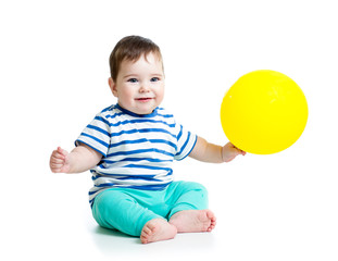 Smiling baby boy  with ballon in his hand isolated on white