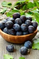 Plums in wooden bowl