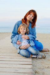 mother and daughter resting near the sea