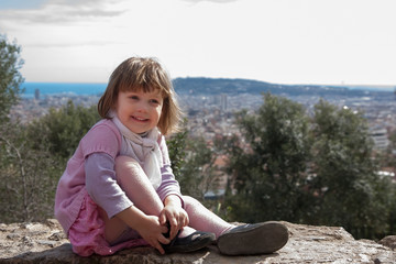 Smiling girl sitting in spring park