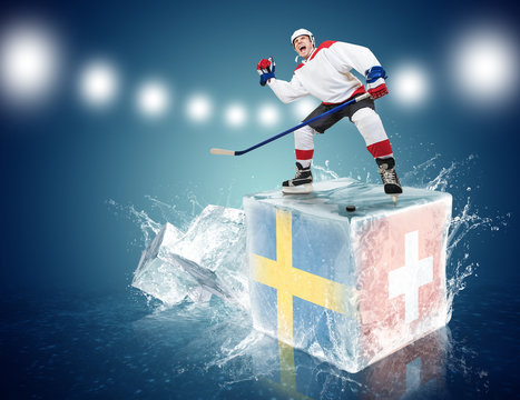 Sweden - Switzerland game. Spunky hockey player on ice cube