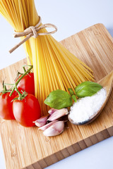 Whole wheat spaghetti and vegetables on wooden tabletop