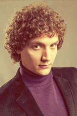 Obraz premium Detailed portrait of a young caucasian guy with curly hair
