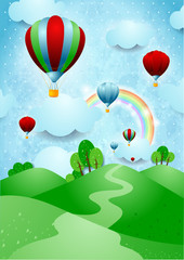 Obraz na płótnie Canvas Hot air balloons over the hills