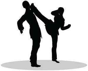 silhouettes of man and woman in karate poses