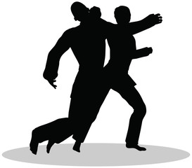 Fototapeta na wymiar silhouettes of man and woman in karate poses