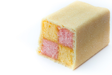 Cake, pink and yellow sponge squares in a marzipan coating