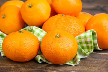 Ripe sweet tangerines on color wooden background