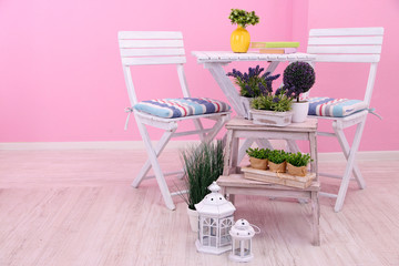 Garden chairs and table with flowers
