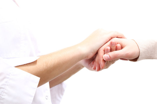 Medical doctor holding hand of patient, isolated on white