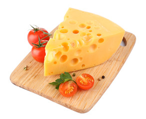 Piece of cheese and tomatoes, on wooden board, isolated on