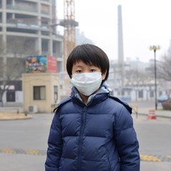 Asian boy wearing mouth mask against air pollution (Beijing)