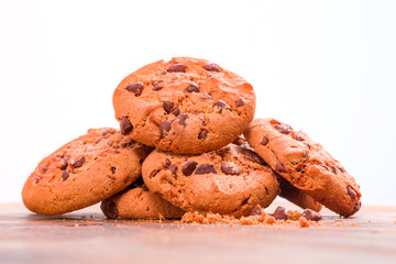 Stack of Chocolate chip cookies on wooden background.