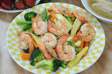 Mix vegetables fried with shrimps on table