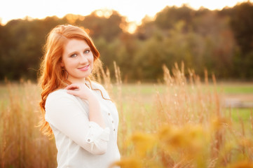red haired girl in a field