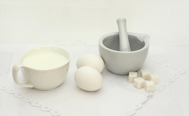 White utensils and meal on a white background