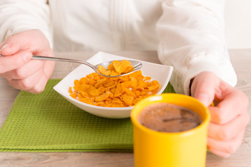 Woman eating breakfast at home