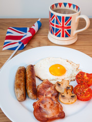 Bacon and eggs with cup of tea and british flag