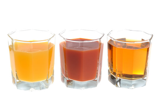 Three glasses filled with various kinds of juice isolated on whi