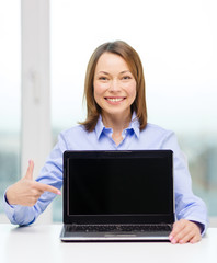 businesswoman with blank black laptop screen