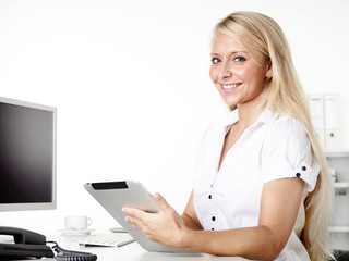 Female office assistant works with tablet at the office