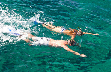 Couple snorkeling in tropics