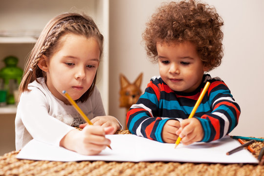Young girl and boy drawing