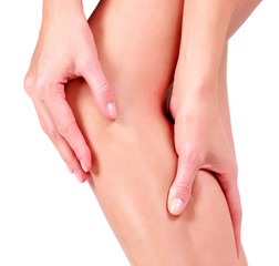 Woman holding sore knee, on white background