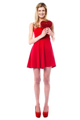 Tall sexy girl holding heart shaped gift