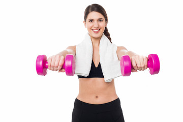 Fototapeta na wymiar Trainer holding dumbbells in her outstretched arms